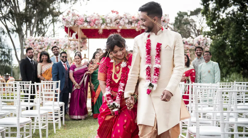Outdoor wedding ceremony with a floral arch, Grand House photography