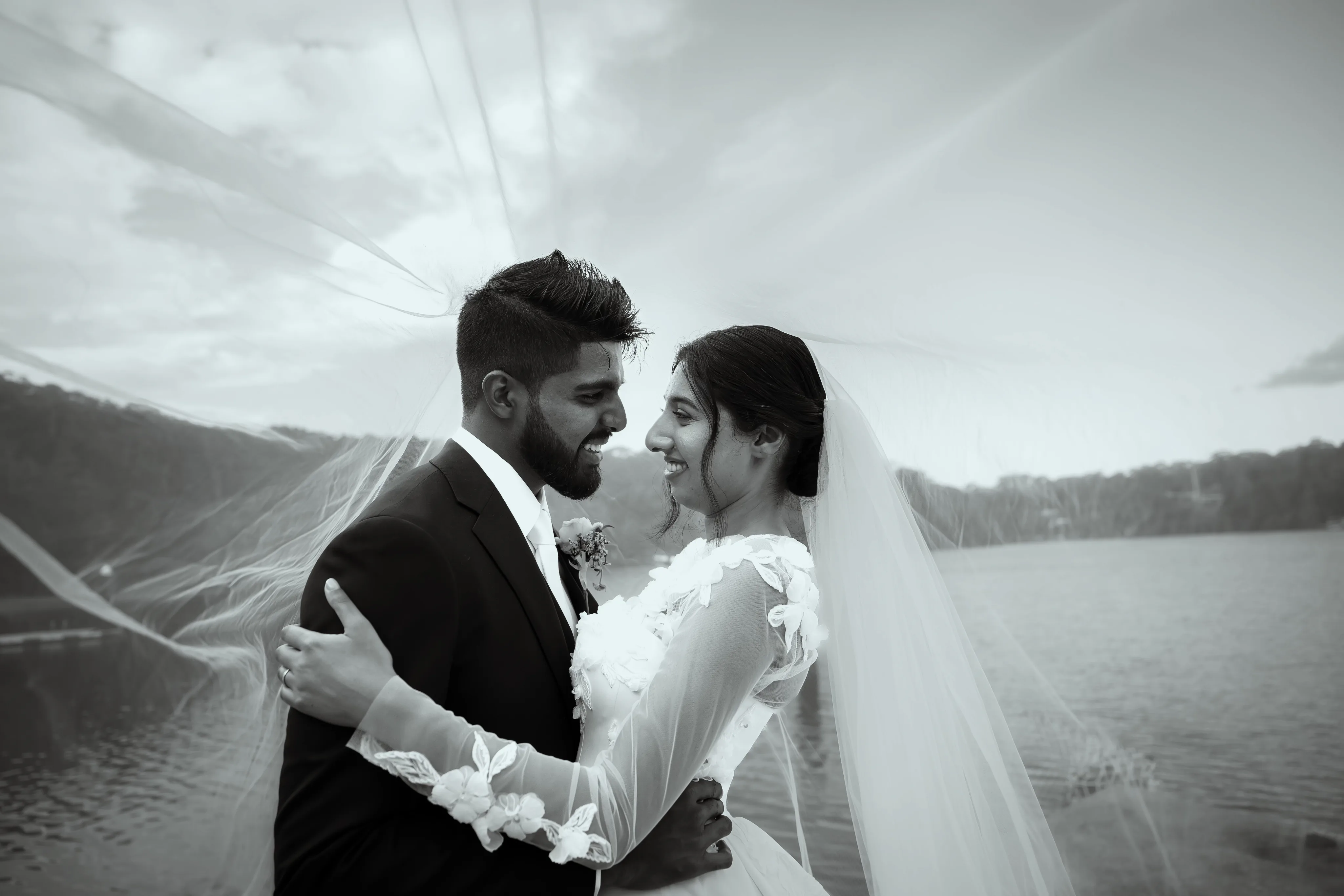 Couple embracing by the water